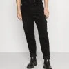 Budget ❤️ Karl Kani UNISEX RETRO PANTS - Stoffhose - Black ⌛