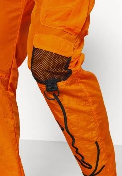 Besorgen 😀 Karl Kani SIGNATURE CRINCLE PANTS UNISEX - Cargohose - Orange ✨ -Karl Kani Verkäufe 7a99ca0439184026a0d949411495245c