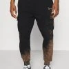 Bestpreis 🎁 Karl Kani SMALL SIGNATURE BLEACHED UNISEX - Jogginghose - Black 👏