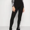 Top 10 🥰 Karl Kani RETRO SLIT - Leggings - Hosen - Black, Damen ⭐